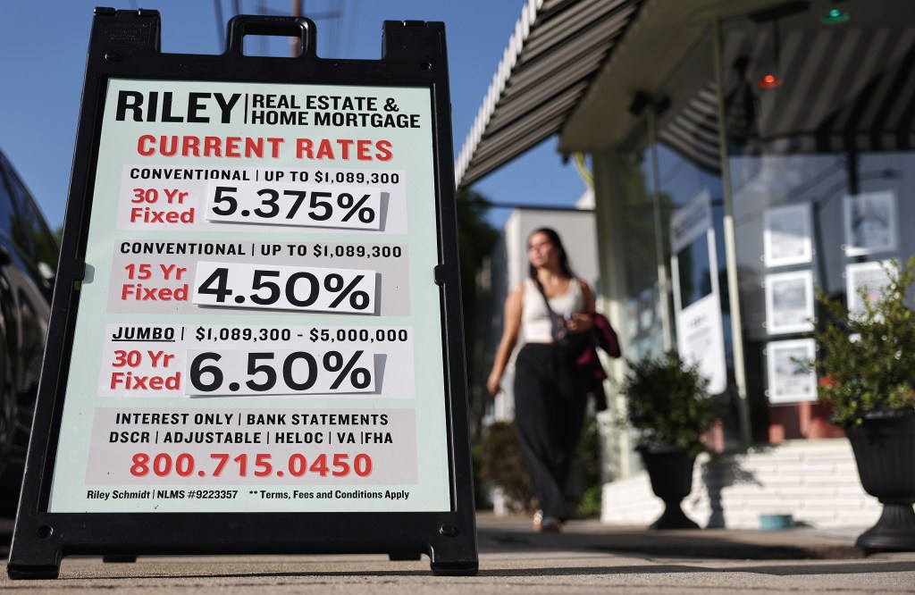 Home mortgage rates are posted outside a real estate office 